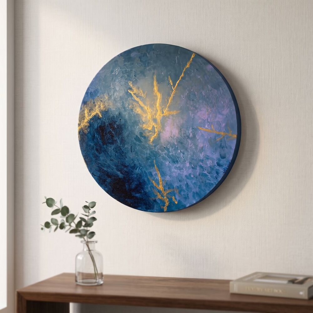 Round abstract canvas painting displayed on a wall above a wooden console